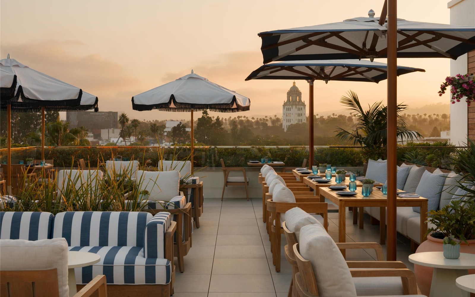 The sunset side of Poza, the rooftop restaurant and bar, with the City Hall tower and the palm line beyond