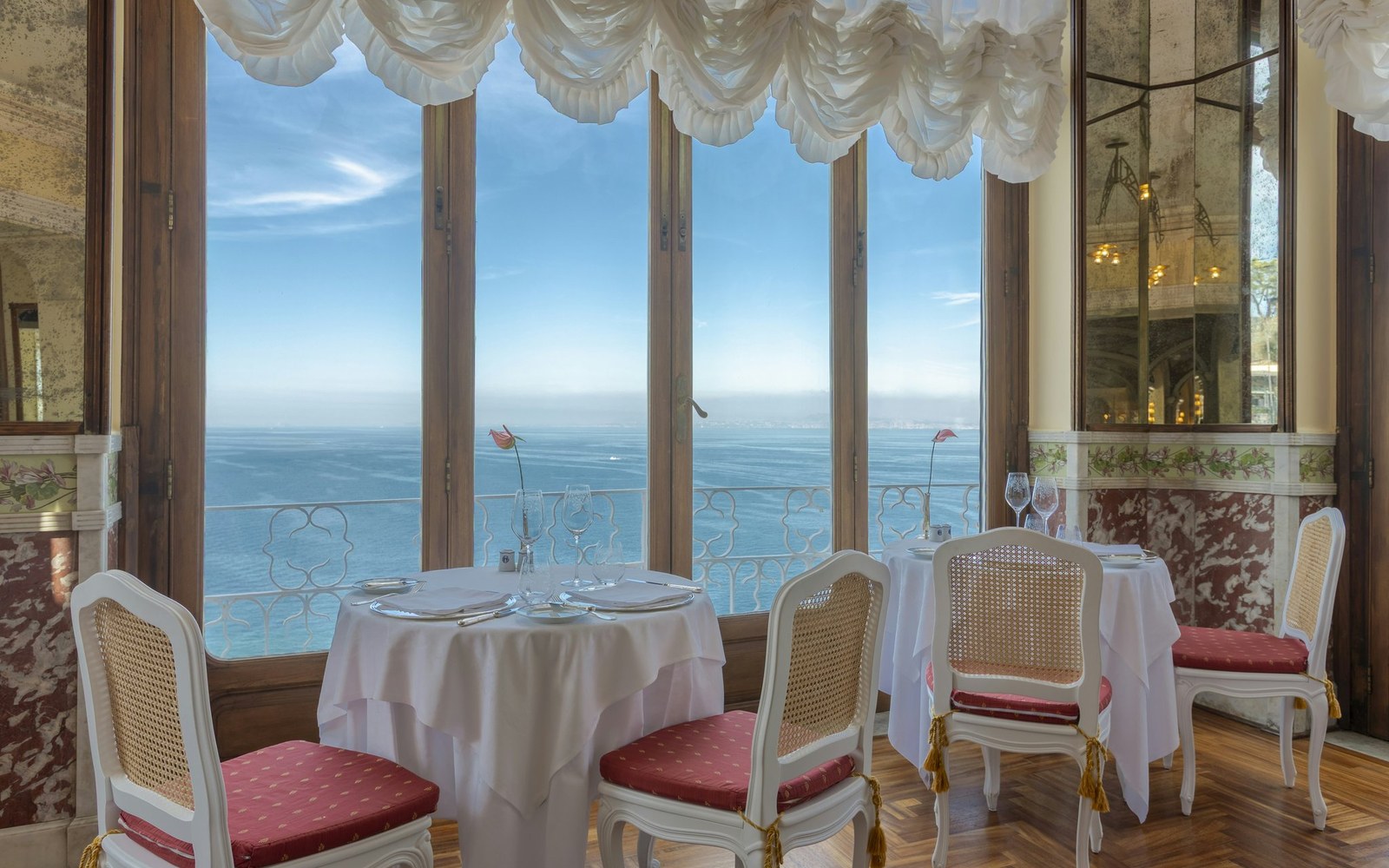 The sea-facing windows of the indoor dining room, looking out over the Bay of Naples