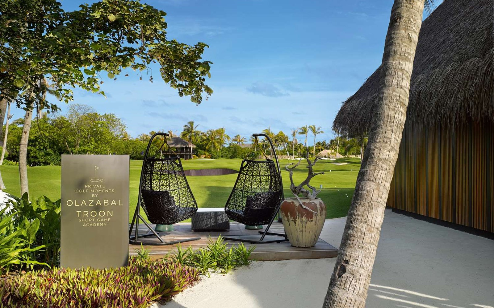 The golf academy designed by Jos&eacute; Mar&iacute;a Olaz&aacute;bal, its practice ground set against the palms